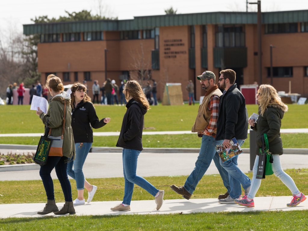 Students & parents walk on an outdoor path while on a tour of the Valpo campus.